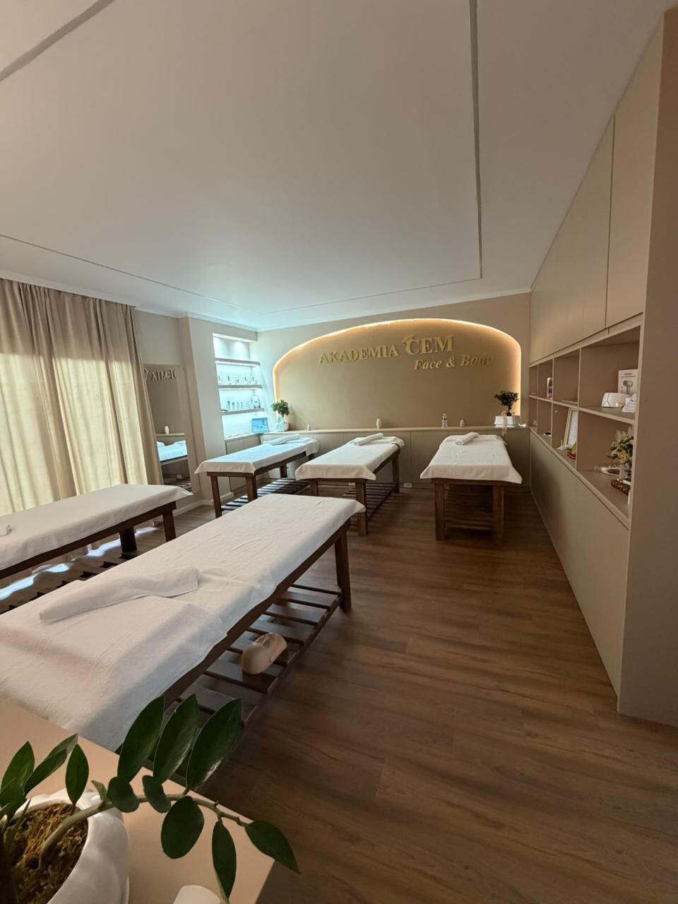 The Face and Body studio seen along the row of five treatment beds towards the product display.