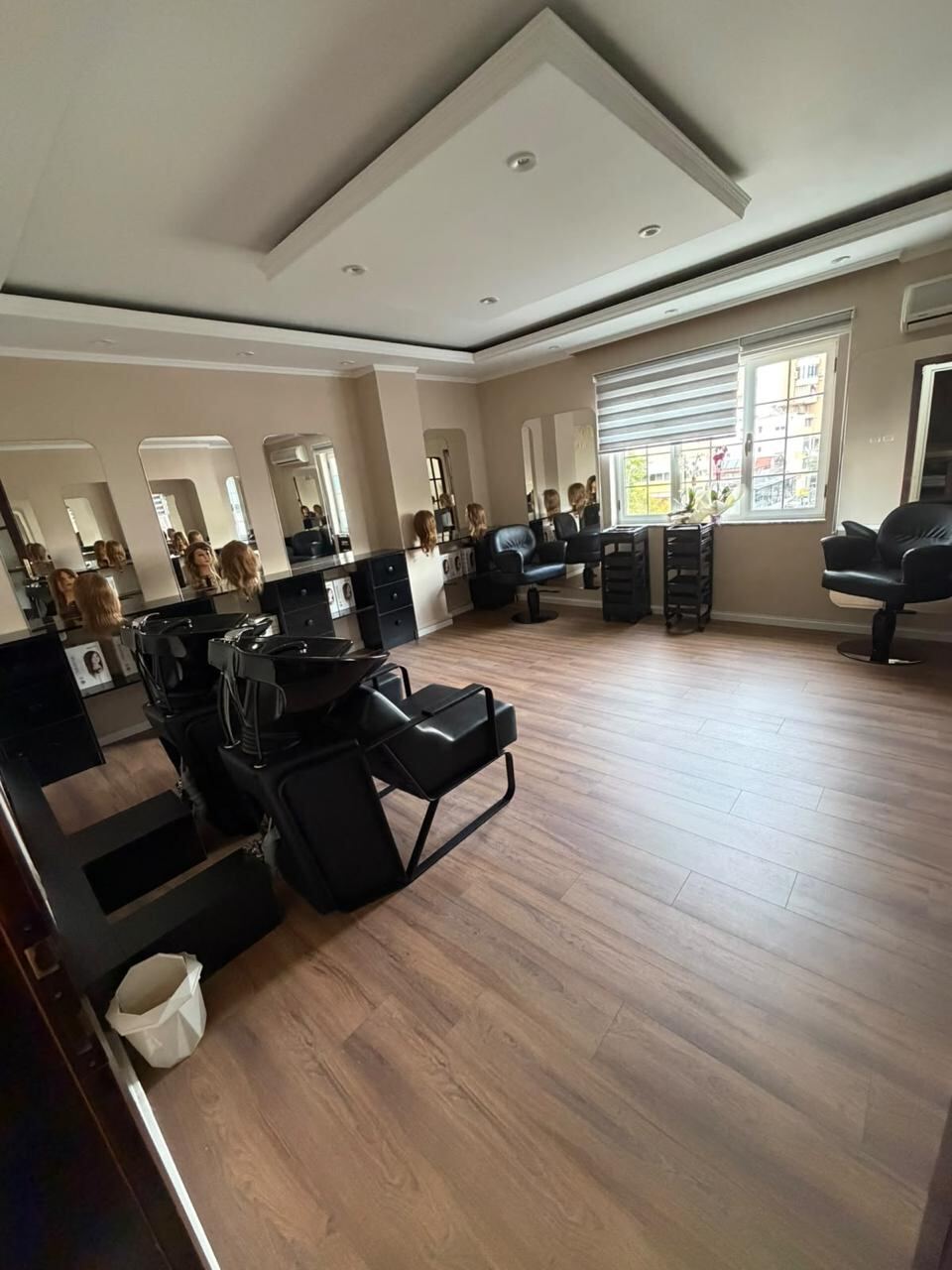 The hairdressing studio: mirrored cutting stations, styling chairs and two backwash units.